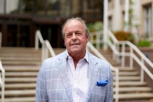 Cllr John Spence standing outside County Hall.